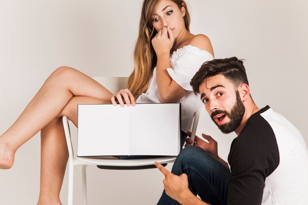 Young couple presenting book