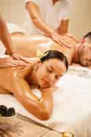 Free photo young couple relaxing during back massage at health spa focus is on young woman