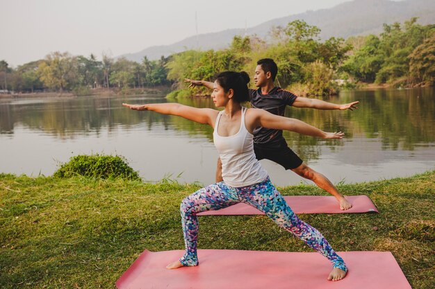 Young couple relaxing with yoga in the nature