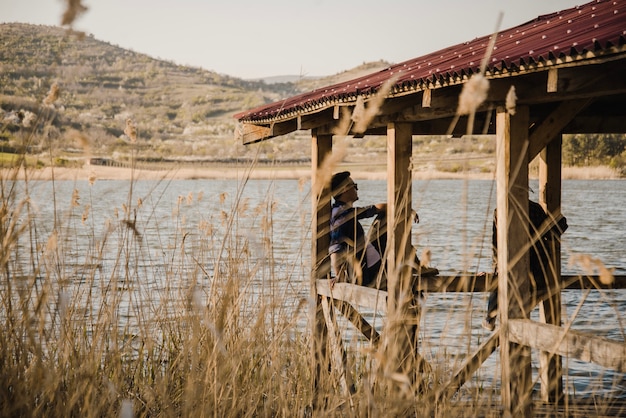 Free Photo young couple resting by the lake