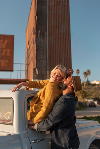 Young couple sharing tender moments on their car trip