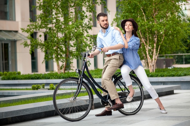 Young couple sitting on a bicycle