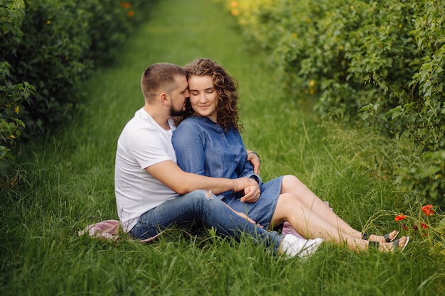 Young couple sitting on grass and relaxing