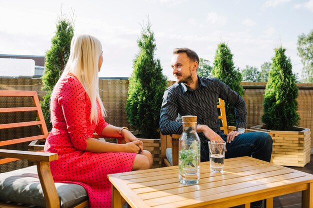 Young couple sitting in rooftop restaurant