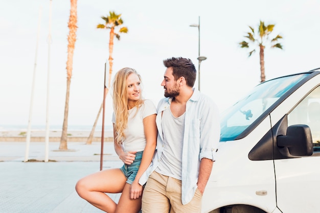 Young couple standing near car