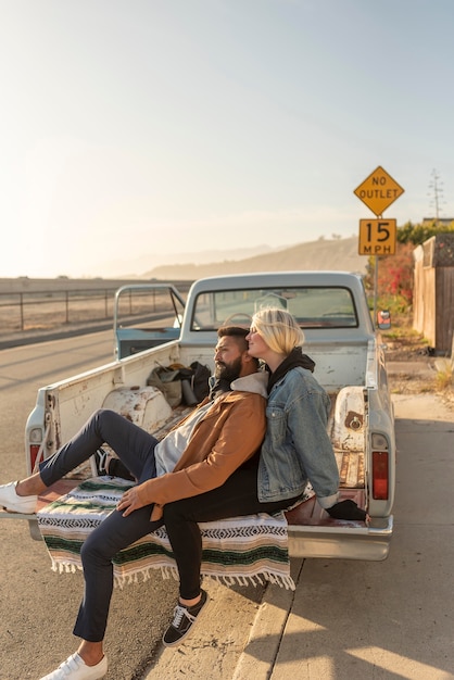 Young couple taking a break in the back of their car