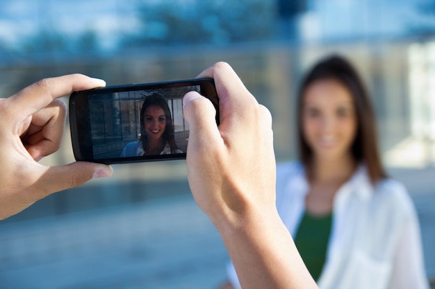 Young couple taking photos with mobile