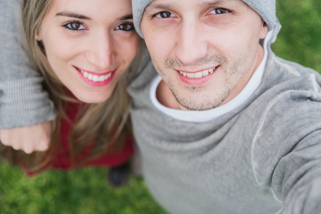 Young couple taking selfie while dating outdoor