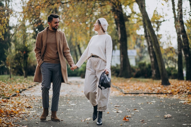 Young couple together in an autumn park