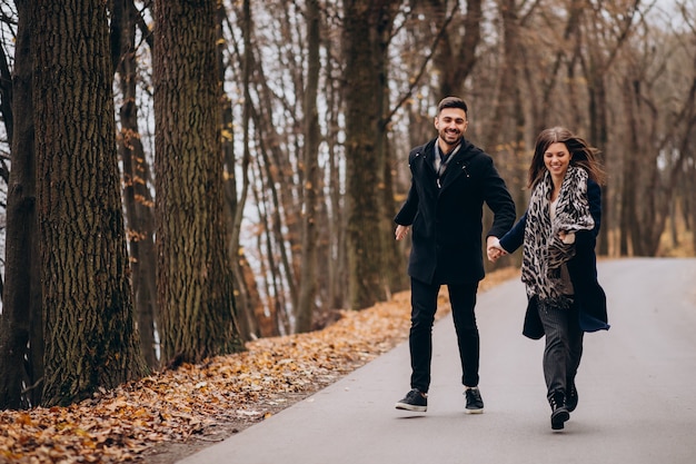 Free Photo young couple together walking in an autumn park