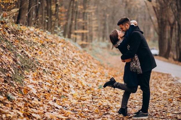 Young couple together walking in an autumn park