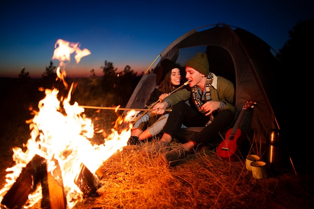 Free photo young couple together with a bonfire