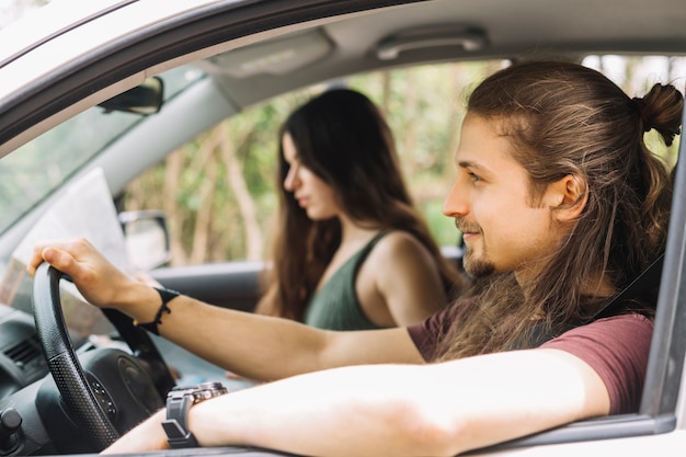 Young couple on a trip in a car