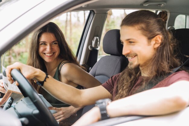 Young couple on a trip in a car