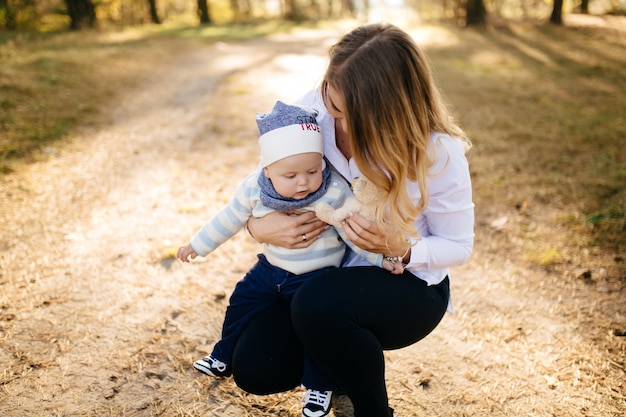 A young couple walks in the woods with a little boy