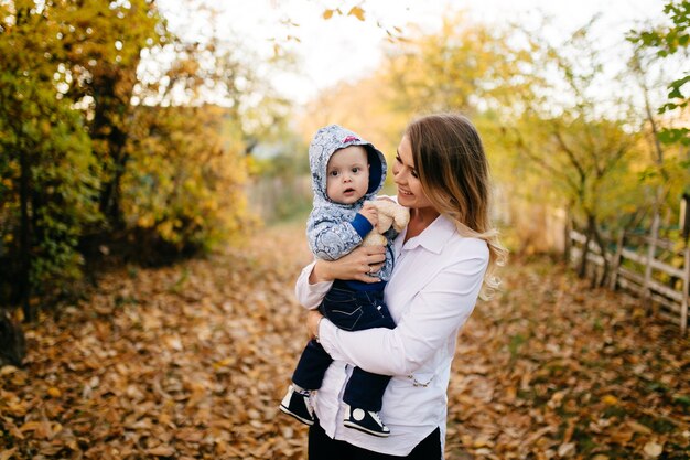 A young couple walks in the woods with a little boy