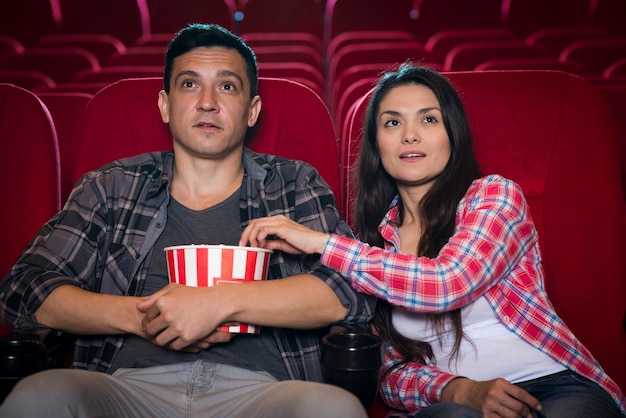 Young couple watching movie in cinema