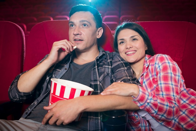 Young couple watching movie in cinema