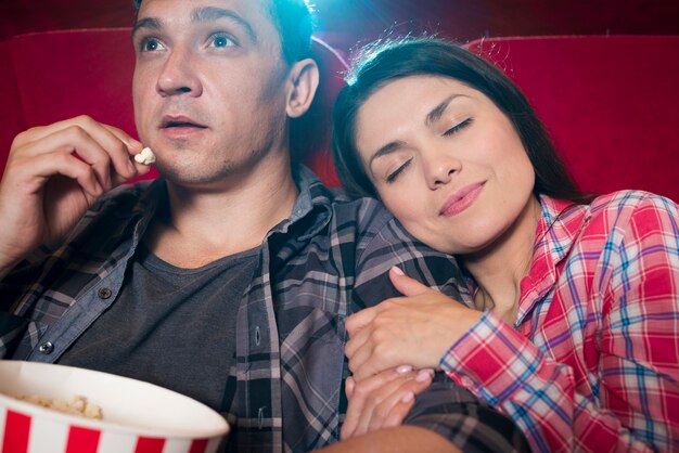 Young couple watching movie in cinema