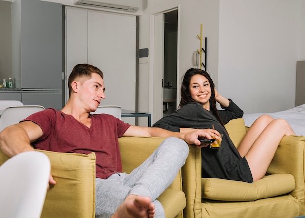 Young couple watching tv at home