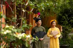 Free photo young couple wearing ao dai costume