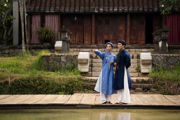 Free Photo young couple wearing ao dai costume