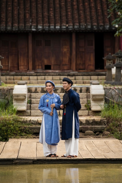 Free Photo young couple wearing ao dai costume