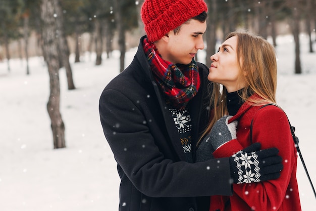 Young couple wearing blanket on a snowy field