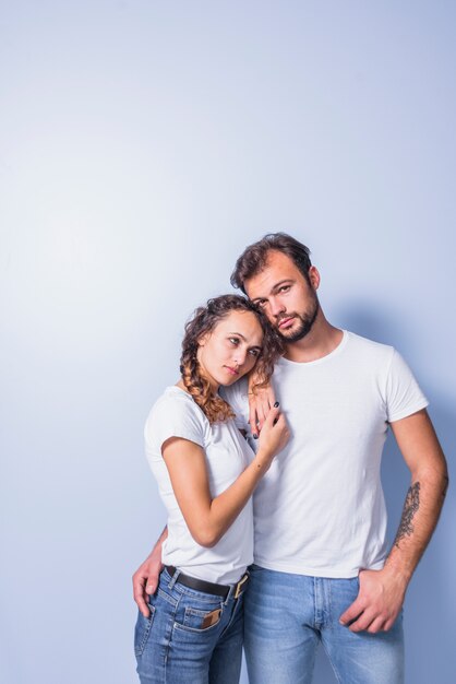 Young couple in white hugging