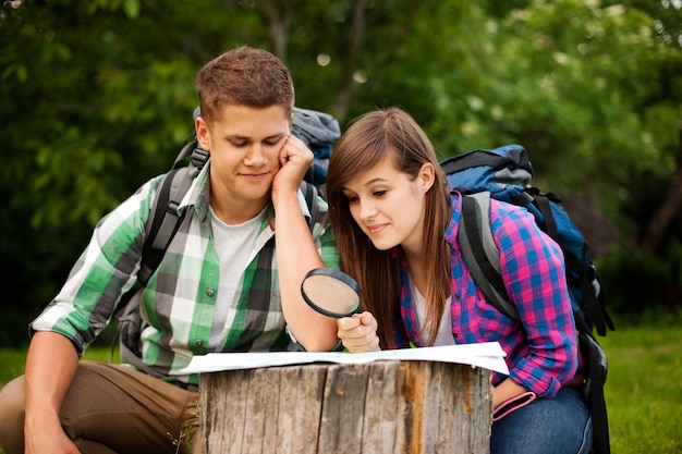 Young couple with map in forest