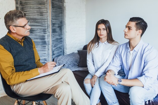 Young couple with problem on reception for family psychologist. Family problems