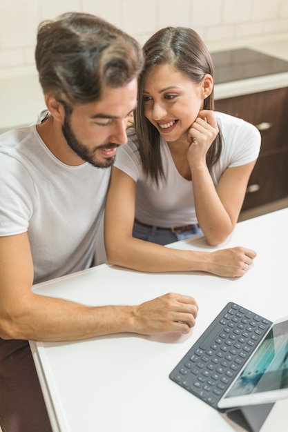 Young couple with tablet in kitchen