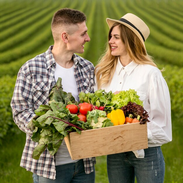 Young couple with vegetables basket