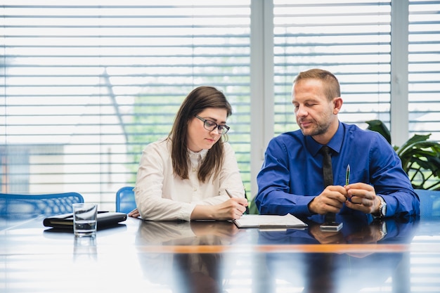 Free Photo young coworkers with documents at table