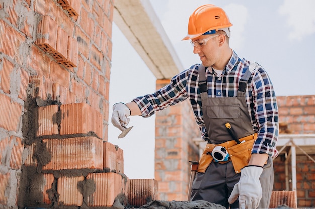 Free Photo young craftsman building a house