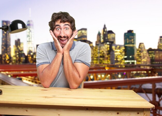 young crazy man on a table surprised expression