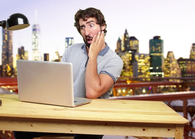 Free Photo young crazy man on a table surprised expression