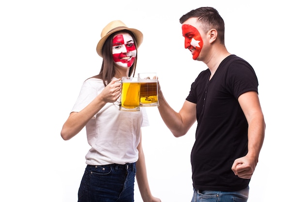 Young croatian and tunisia football fan with beer isolated on white wall