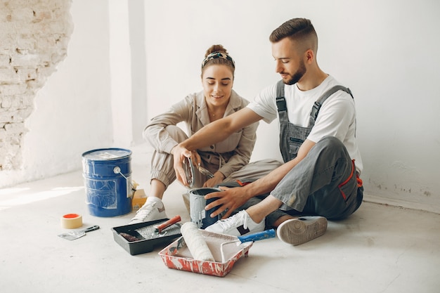 The young and cute couple repairs the room