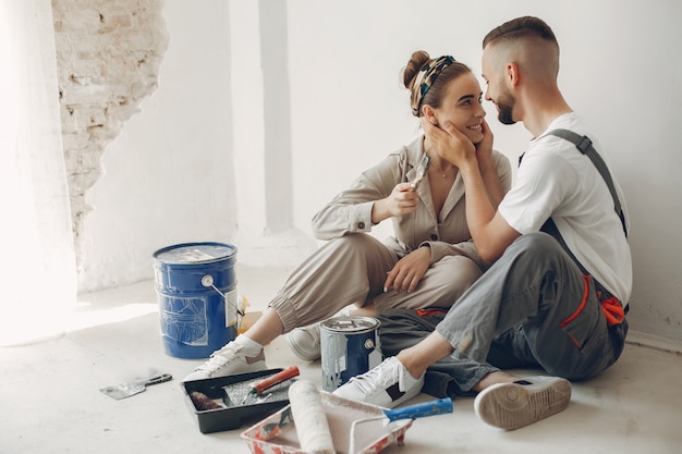 The young and cute couple repairs the room