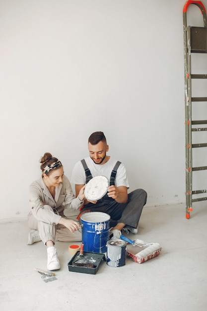 The young and cute couple repairs the room