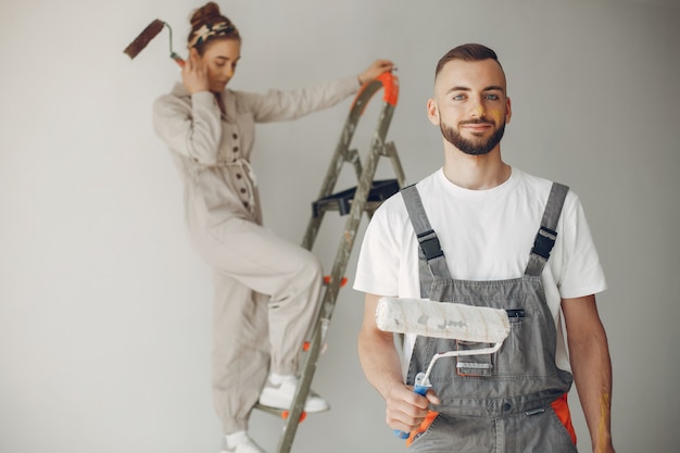 The young and cute couple repairs the room