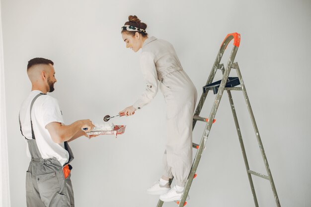 The young and cute couple repairs the room