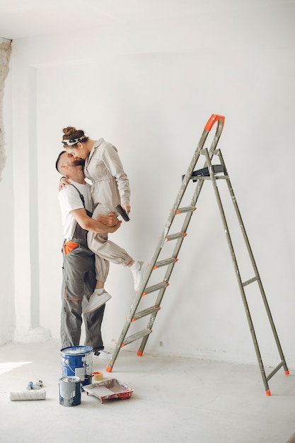 The young and cute couple repairs the room