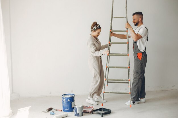 The young and cute couple repairs the room