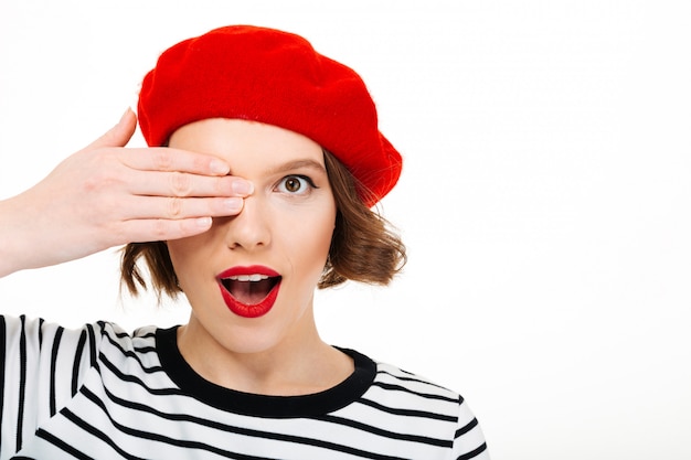 Young cute woman covering eye with hand.