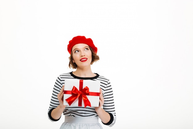 Young cute woman holding gift surprise box.