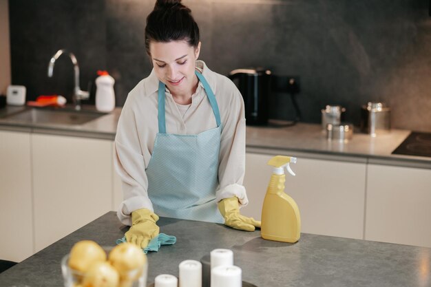 Young dark-haired woman looking busy while doing housework