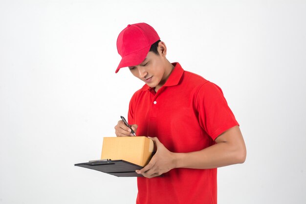 Young delivery man checking list on clipboard isolated on white background