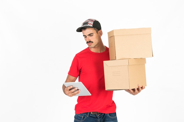 Free photo young deliveryman with boxes